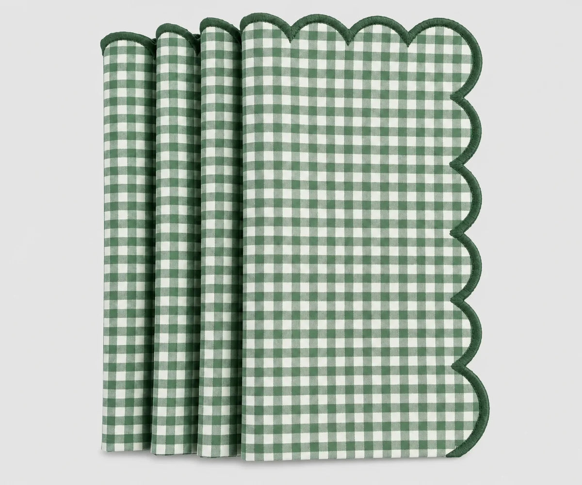 Set of green and white gingham cotton dinner napkins with scalloped embroidered edges.