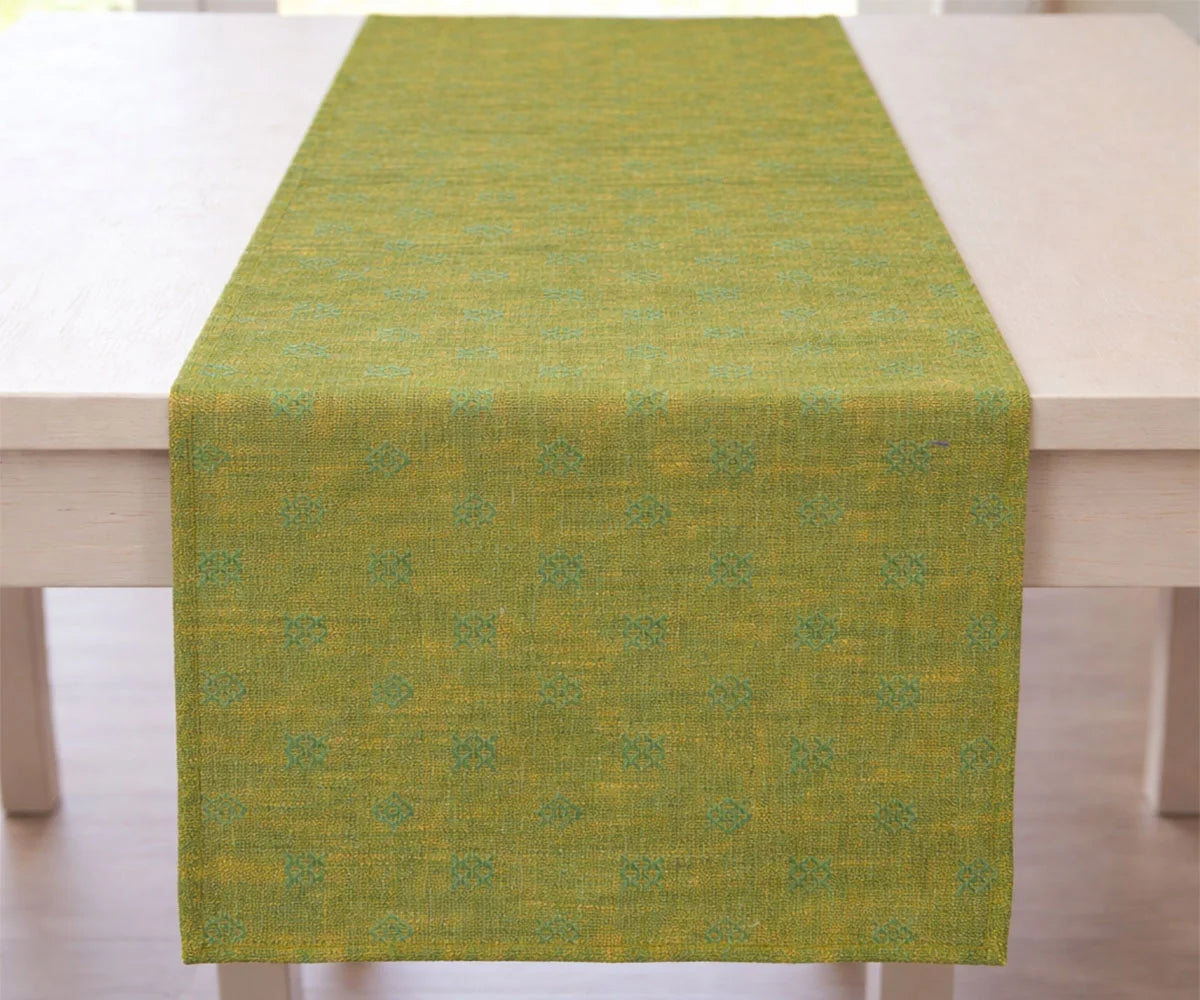 Green and Gold table runner on a wooden table