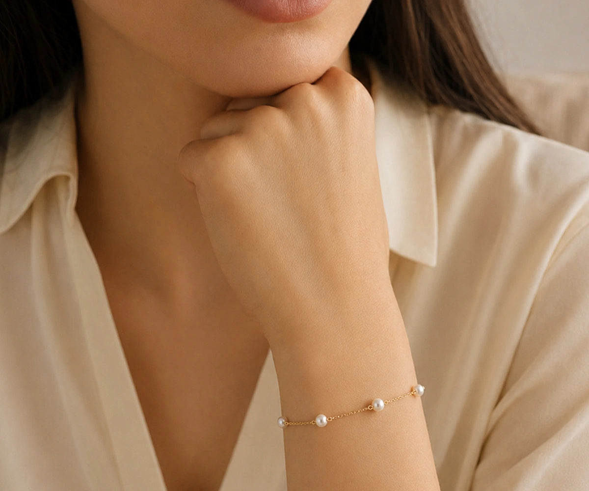 Women's pearl chain charm bracelet styled on wrist, gold pearl bracelet for wedding guest outfit, fashionable charm jewelry, birthday gift for women, elegant everyday bracelet, pearl chain bracelet gift for her