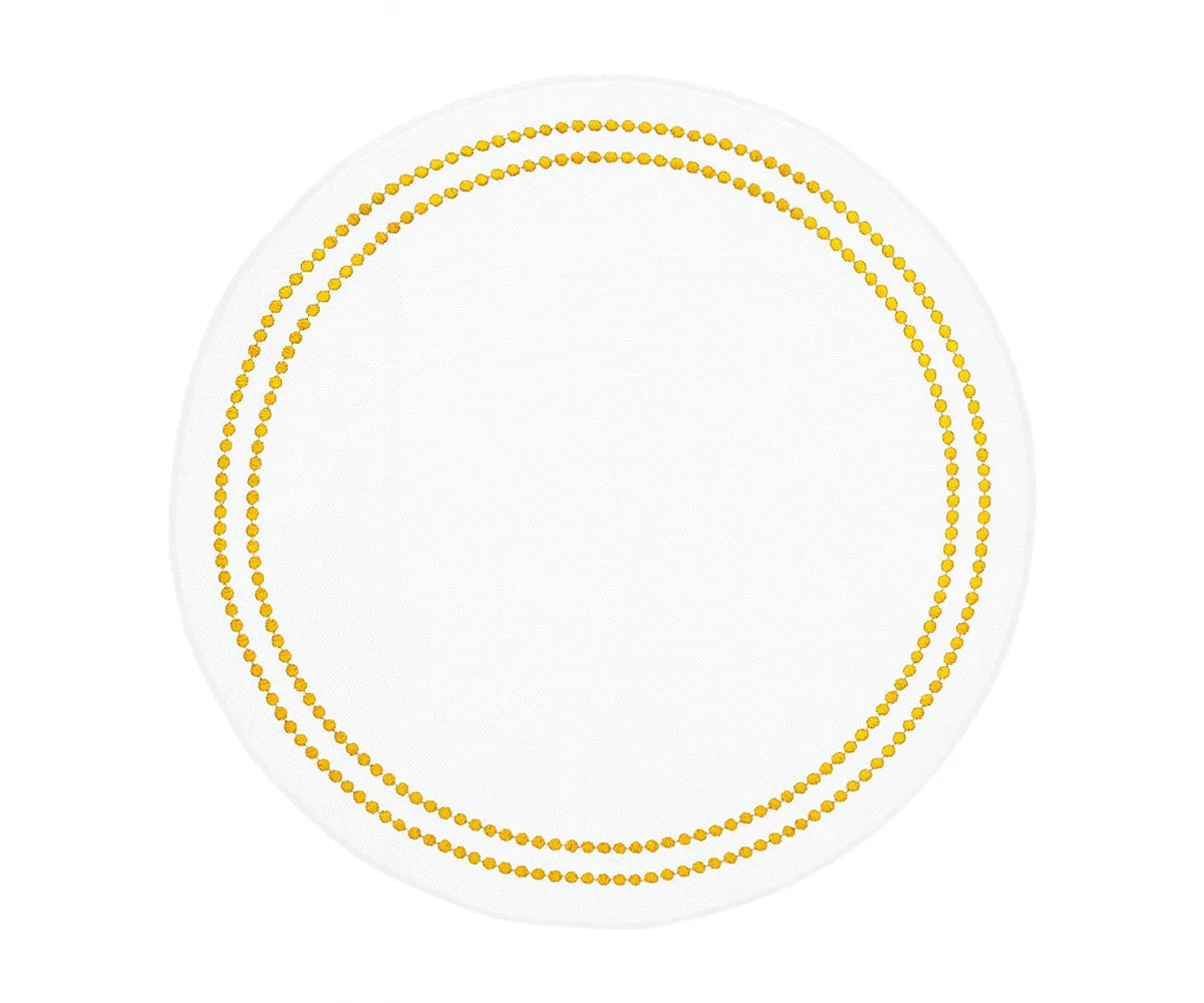 Gold dot white cotton placemats for elegant dining table decor.