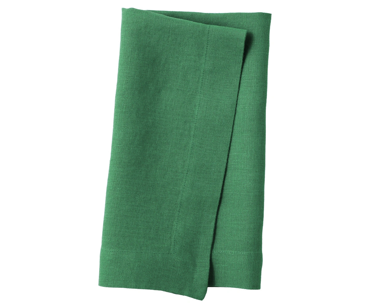 Grass green plain linen napkin with vibrant fresh tone, displayed on table setting