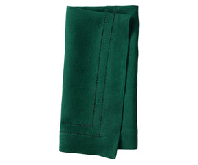 Green linen hemstitch napkins neatly folded on a dining table setup