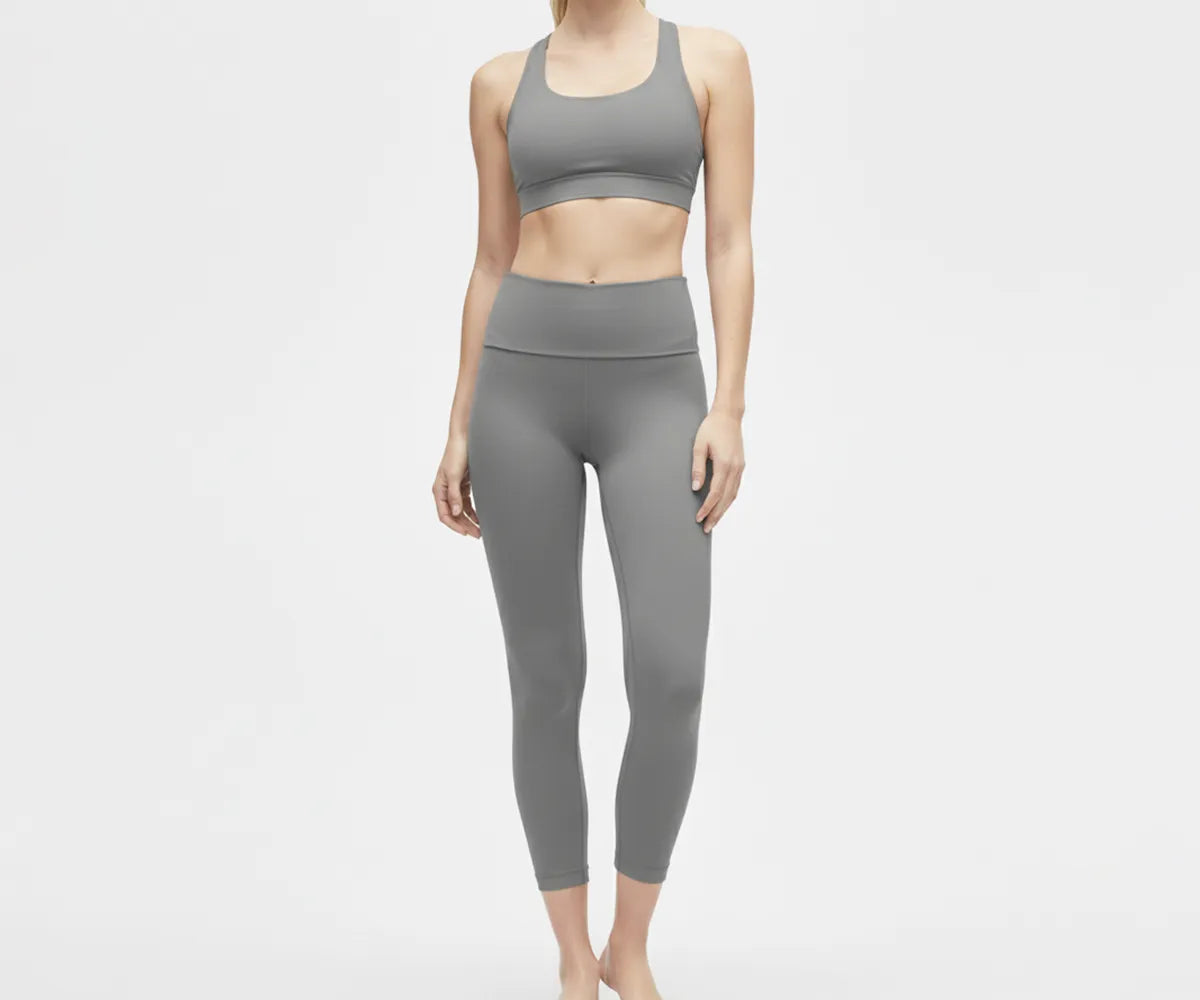 High-waisted grey leggings with a wide supportive waistband made from a soft, breathable cotton blend.