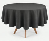 Grey round linen tablecloth with elegant drape, presented on a round wooden dining table