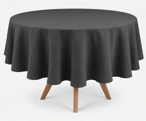Grey round linen tablecloth with elegant drape, presented on a round wooden dining table