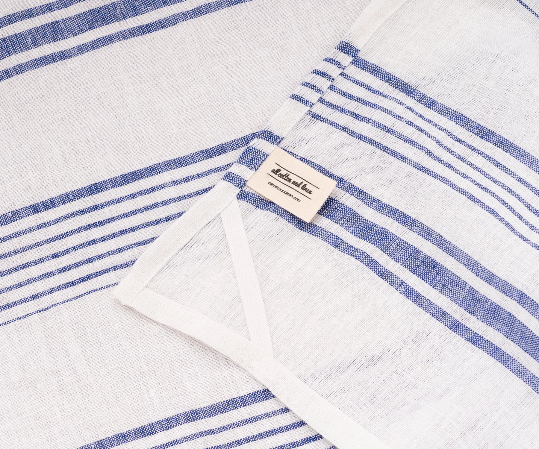 White towel with blue stripe hanging in kitchen