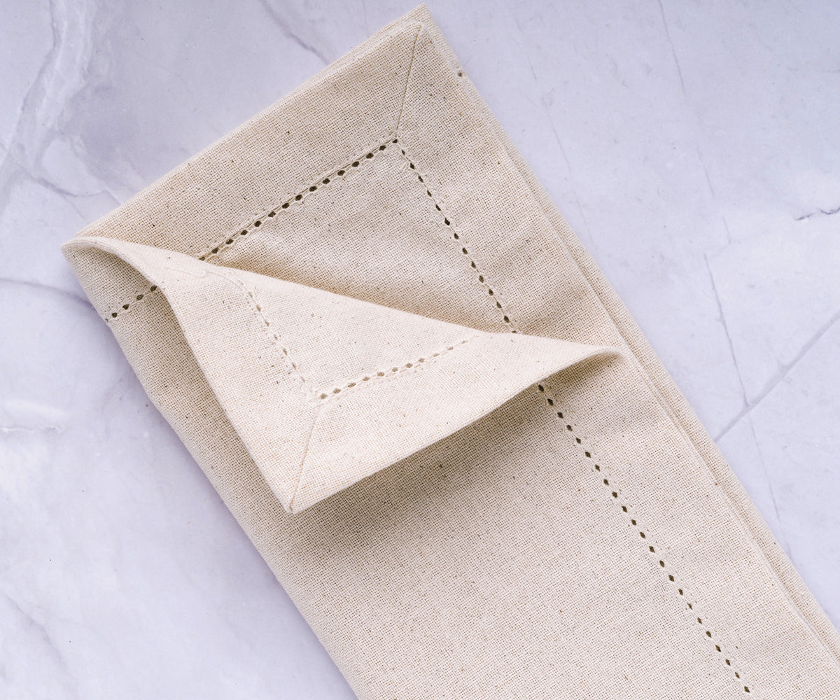 classic hemstitch border, these natural napkins showcase intricate craftsmanship, creating a timeless and sophisticated look
