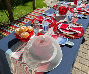 Elegant red cotton napkins with classic single hemstitch border, displayed in a stacked arrangement