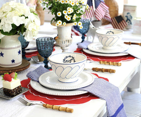 Red round placemats arranged on a dining table, creating a vibrant and stylish setting for a meal.