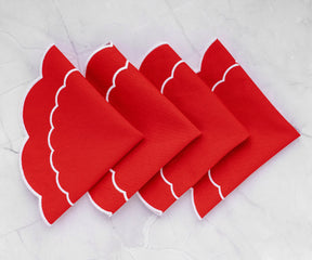Elegant red placemats with a scalloped edge, perfect for a sophisticated table setting.