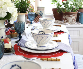 Set of red round placemats neatly arranged, creating a striking contrast with the table surface.