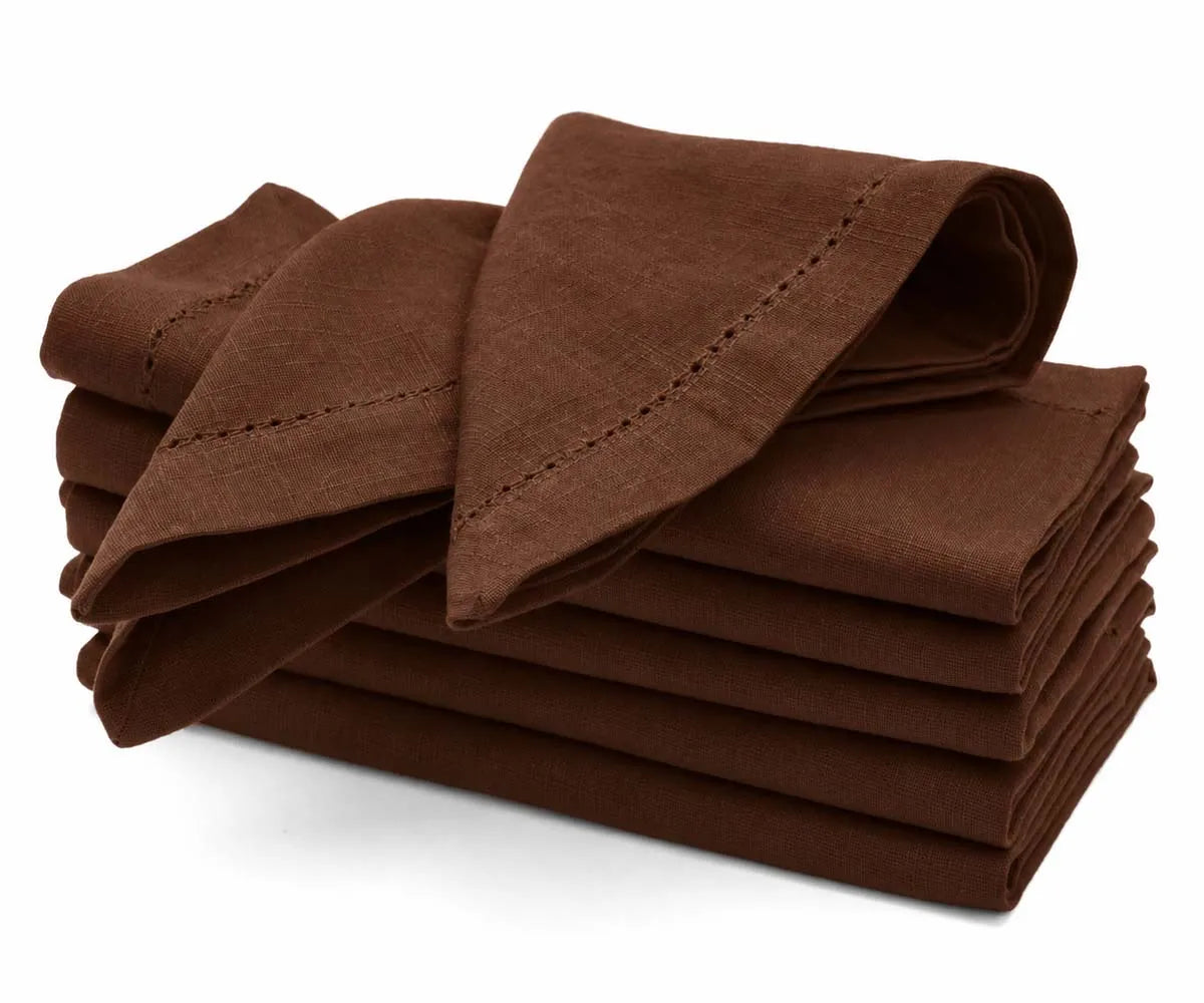 Stacked set of coffee brown cotton hemstitch dinner napkins with decorative border detailing
