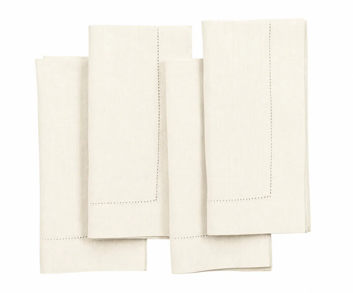 Set of four folded ivory linen hemstitched napkins on a white background