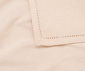Natural-colored hemstitch napkins styled with neutral dinnerware