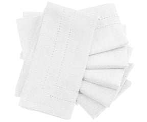 Set of white napkins with decorative edge on a white background