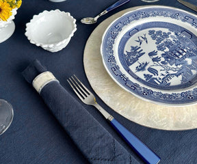 Decorative blue and white patterned plate accompanied by matching napkin