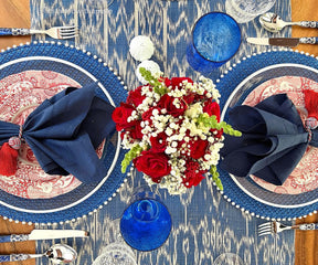 Patriotic table arrangement featuring red, white, and blue Cloth Dinner Napkins