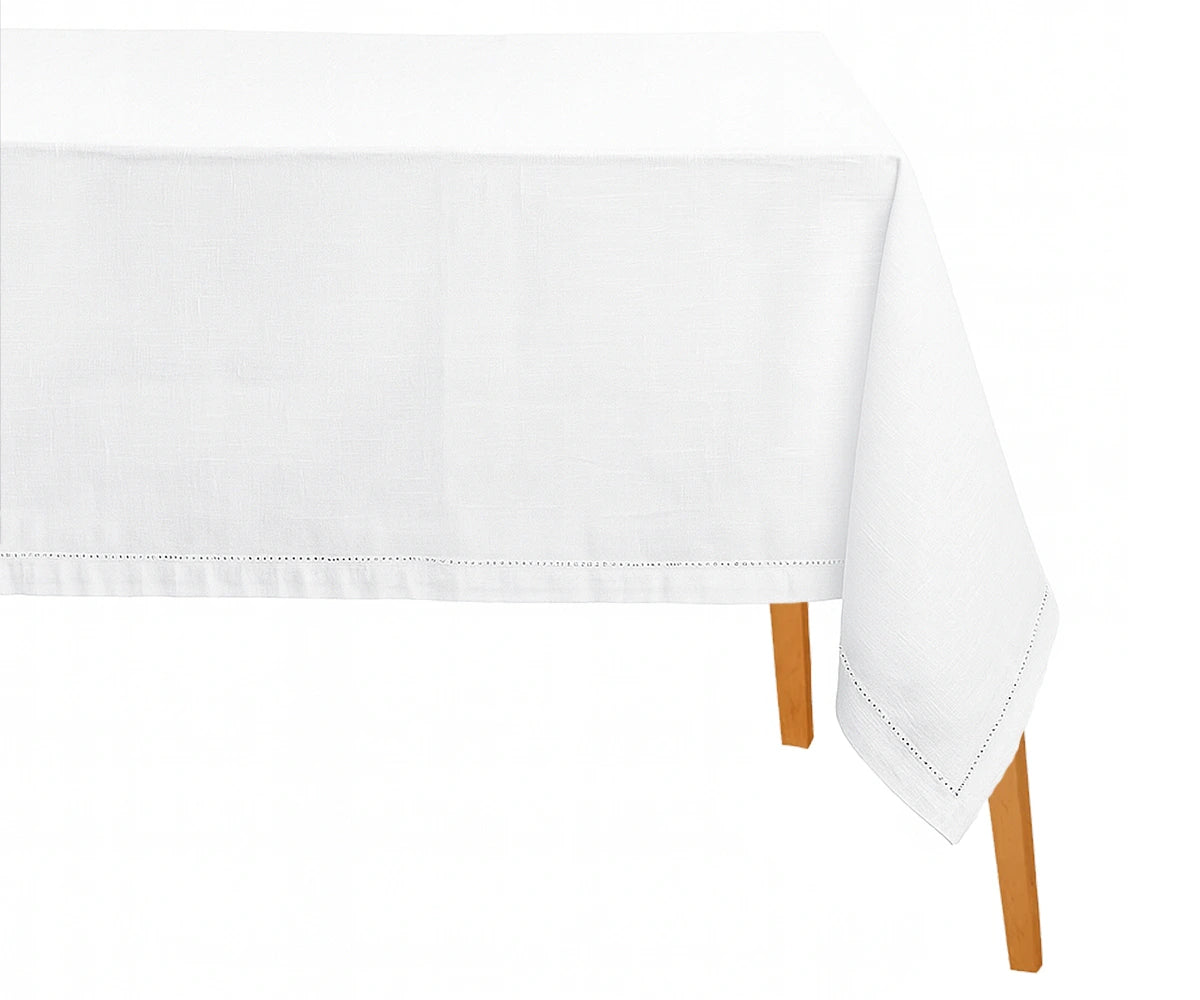 White hemstitched cotton-linen rectangle tablecloth on dining table