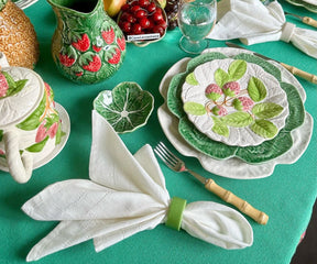 Beautifully folded ivory napkins placed alongside vintage tableware, adding a touch of elegance to the dining experience.