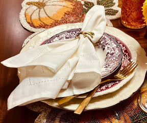 Classic dining setup with a Cloth Dinner Napkin elegantly folded beside gleaming gold utensils