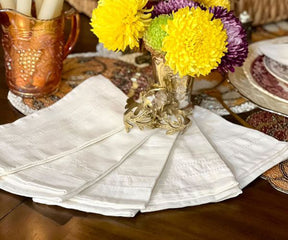 Festive table adorned with Cloth Dinner Napkins and a centerpiece of fresh flowers