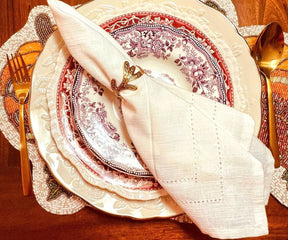 Refined table place setting highlighting a Cloth Dinner Napkin paired with luxurious gold cutlery