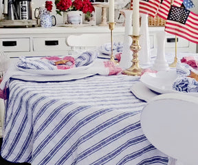 Close-up of a neatly folded linen tablecloth with a soft texture.