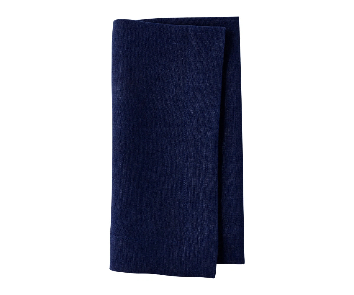 Indigo plain linen napkin neatly stacked, highlighting deep blue shade and fine weave