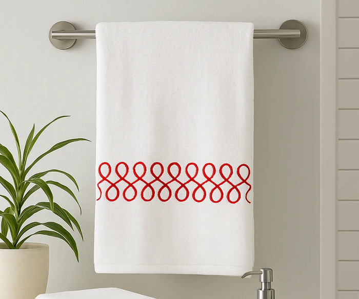 White cotton bath towel with red embroidered design, 100% cotton, soft and absorbent, perfect for spa-like comfort after showers or baths.