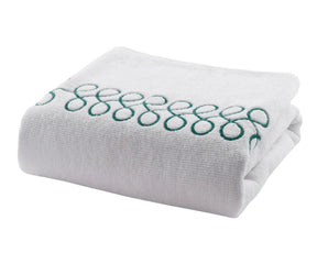 Plush cotton bath towels in white with green embroidery offering high absorbency