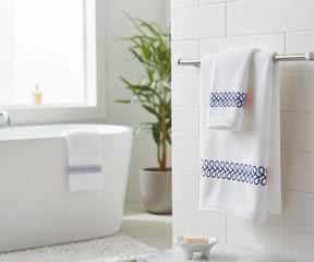 Soft white bath towel with navy embroidered border for stylish bathroom décor