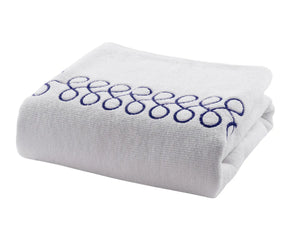 Plush cotton bath towels in white with navy embroidery offering high absorbency