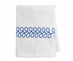 High-quality embroidered cotton bath towels in white with royal blue detailing