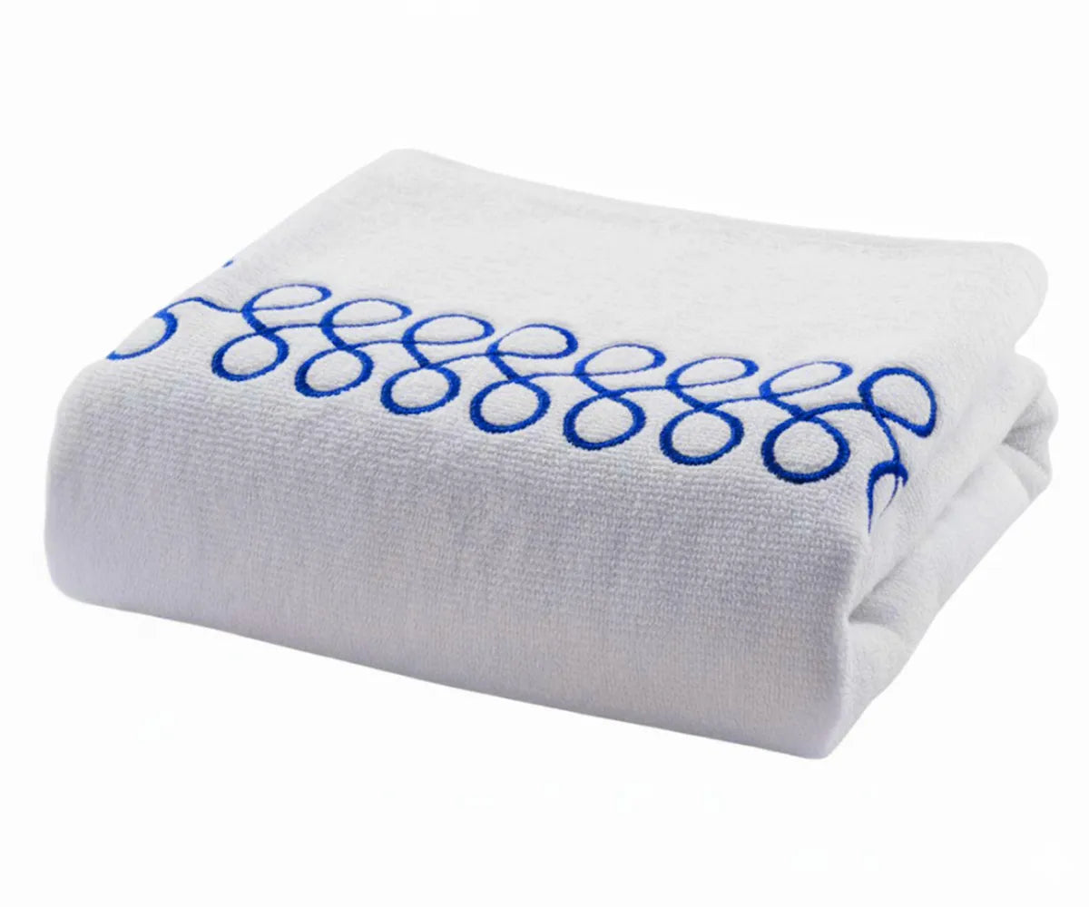 Plush white bath towels with royal blue embroidery offering spa-like comfort and absorbency