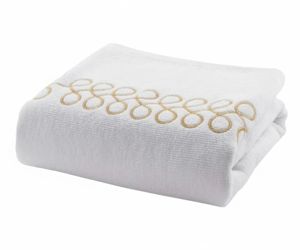 Luxury cotton bath towels in white with beige embroidery for elegant bathroom décor