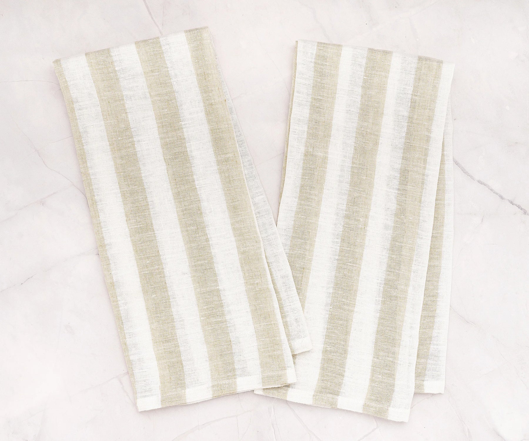 Striped linen tea towel hanging on oven handle