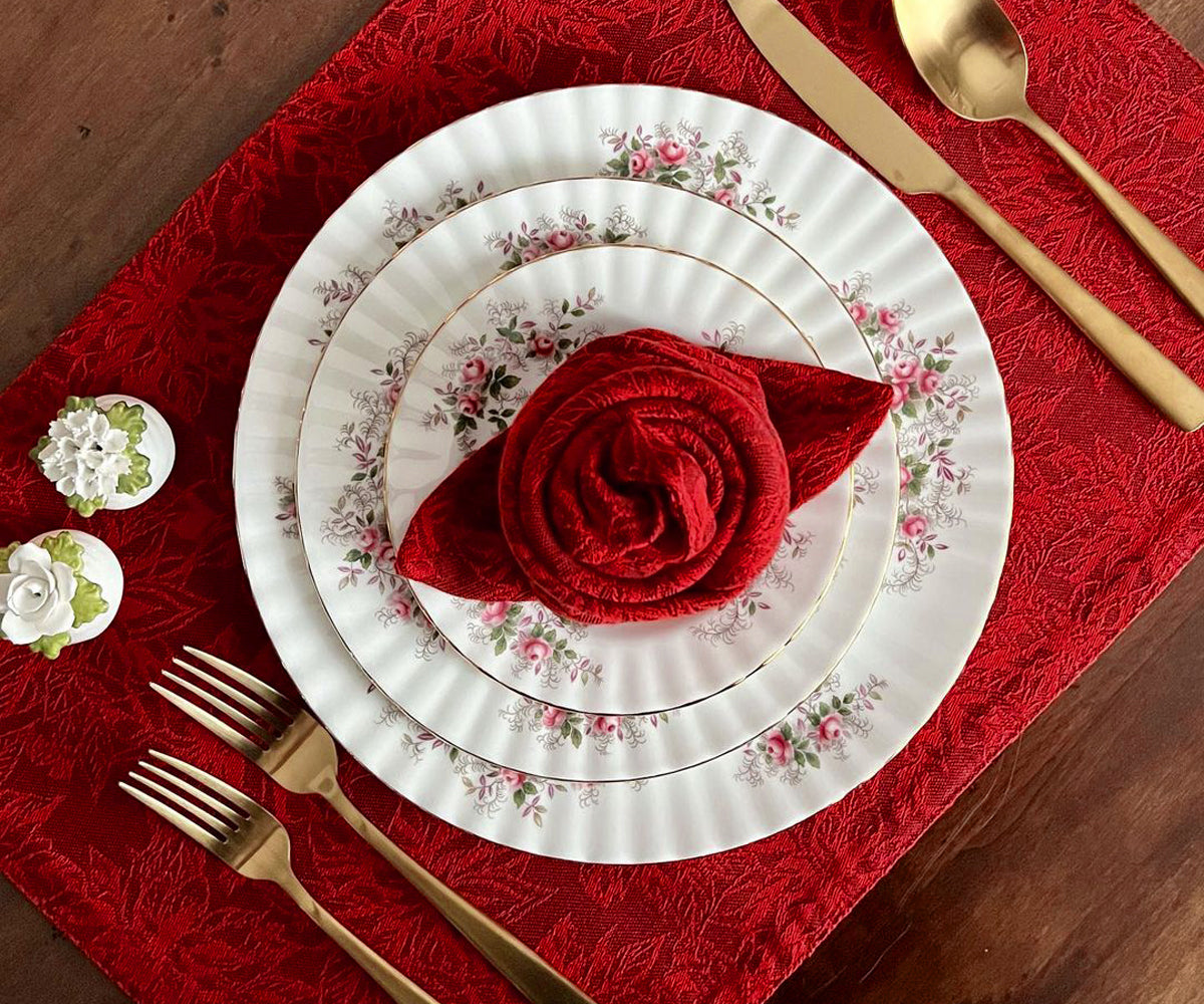 Add a touch of elegance to your table with these striking red fabric placemats, offering both style and protection.