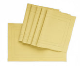 Lemon yellow double hemstitched cotton placemats on a striped tablecloth, 13x18 inches