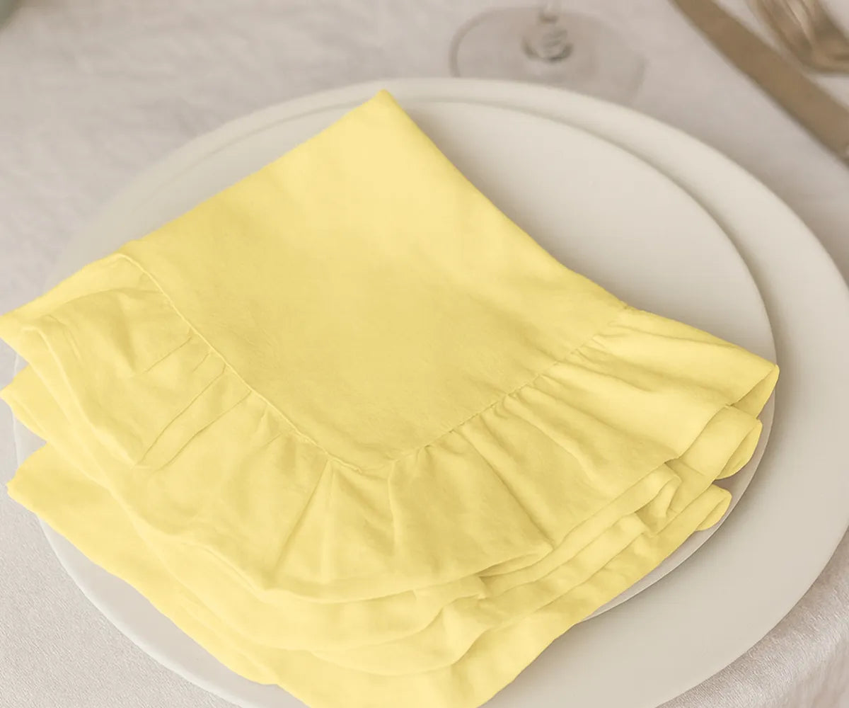 Set of 100% cotton yellow ruffled napkins, washable and eco-friendly fabric dinner napkins available in bulk or small sets, perfect for everyday dining and festive occasions.