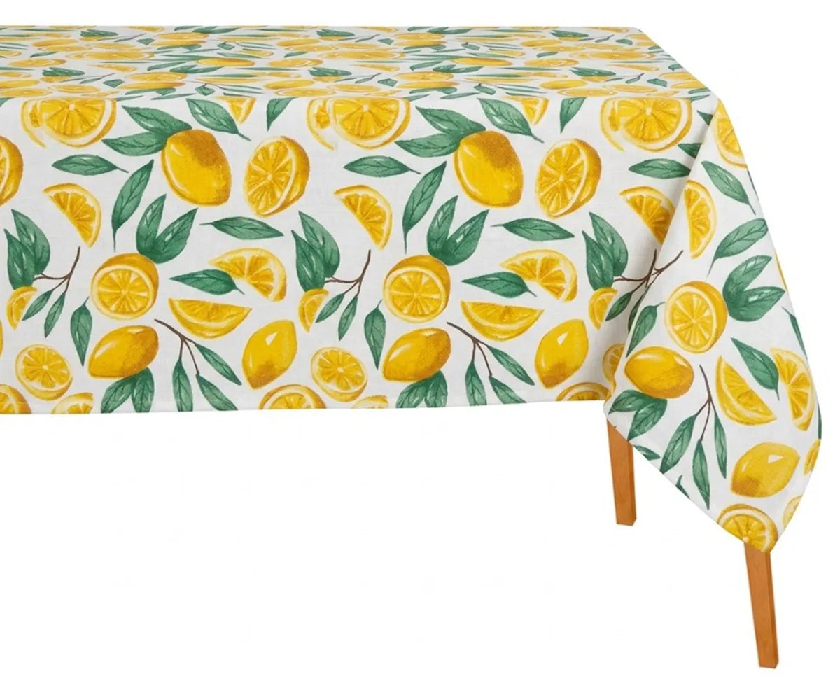 Lemon print cotton tablecloth in yellow and green with leaf pattern on rectangular dining table, soft reusable fabric for indoor outdoor summer dining decor
