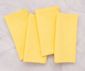 100% cotton lemon yellow napkins stacked and ready for dining use.