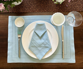 Transform your dining experience with blue pattern placemats, adorned with a trendy buffalo plaid design, adding both style and functionality.
