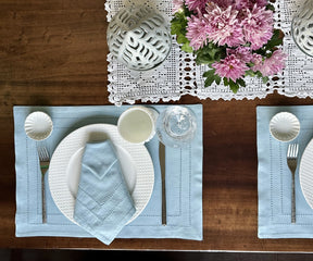 Sophisticated dining arrangement with Cloth Dinner Napkins, blue plates, and coordinated tableware