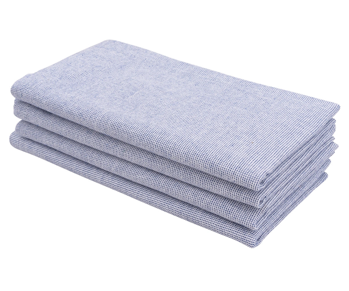 light blue cotton dinner napkin folded neatly on a rustic wooden table.