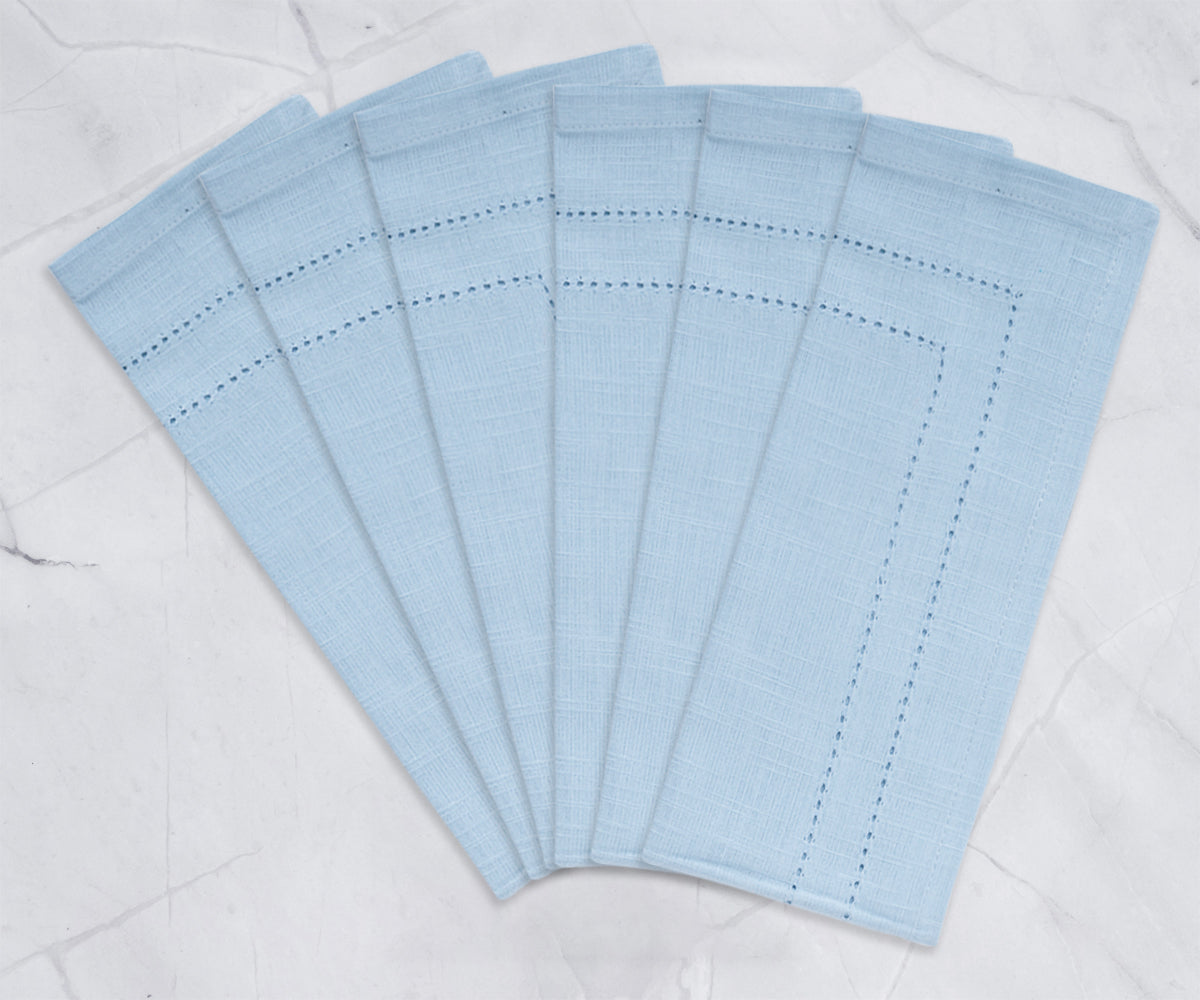 A set of baby blue cloth napkins with a delicate linen hemstitch pattern.