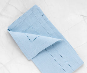 Unique blue Cloth Dinner Napkin with an eye-catching pattern of cut-out holes