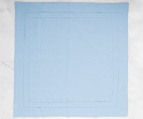 Light blue cloth napkins, crafted with precision hemstitching for a refined look.