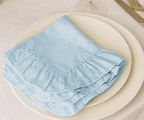 Light blue cotton ruffle edge dinner napkins, reusable and washable cloth napkins for weddings, parties, holidays, and everyday dining table décor.