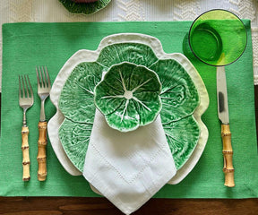 Add a touch of elegance to your table with these striking green fabric placemats, offering both style and protection.