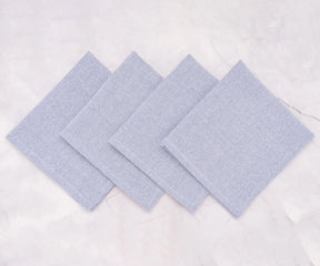 Set of light blue cloth napkins arranged elegantly for a casual dinner setting.